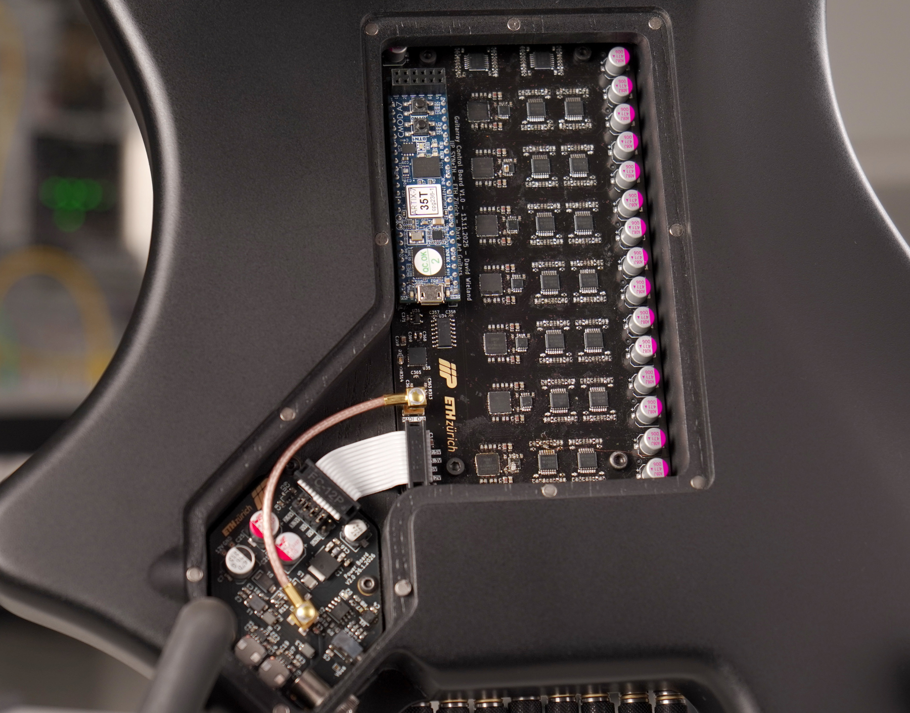 原论文 Figure 4：View of the back of the guitar, showing the control electronics (cover removed).